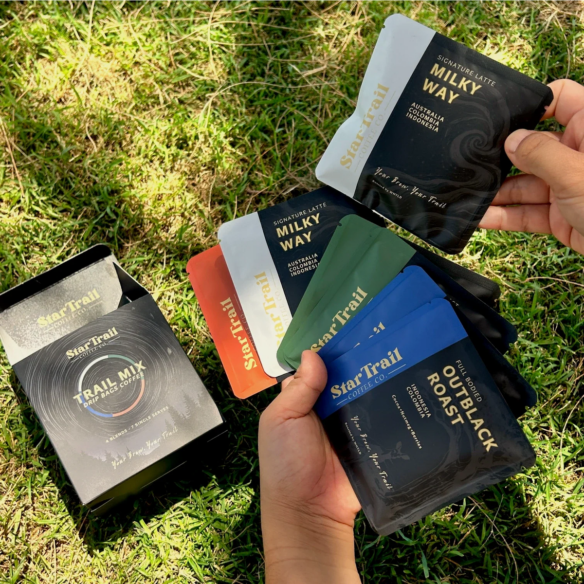Assorted StarTrail coffee drip bags in an outdoor setting