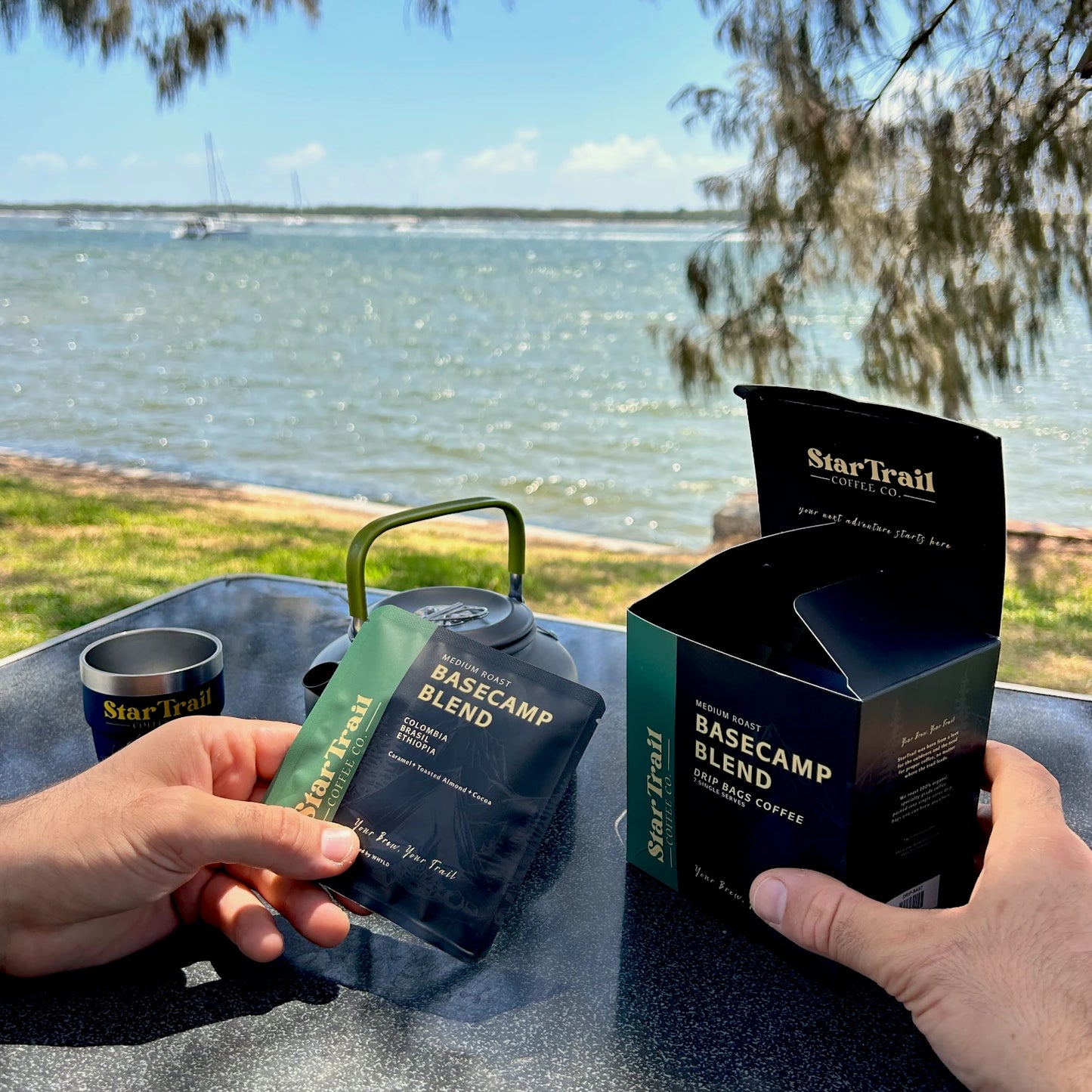 Star Trail coffee basecamp blend open box to see what's inside  by a lakeside setting